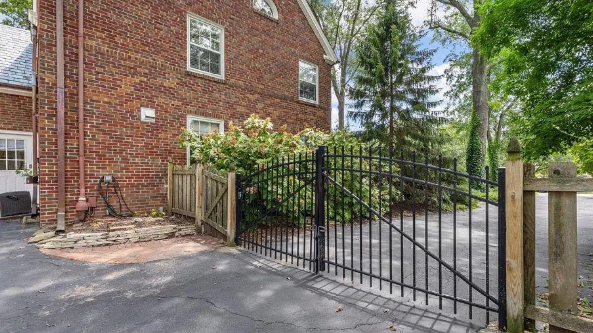 Charming Side Entrance with a Black Iron Gate