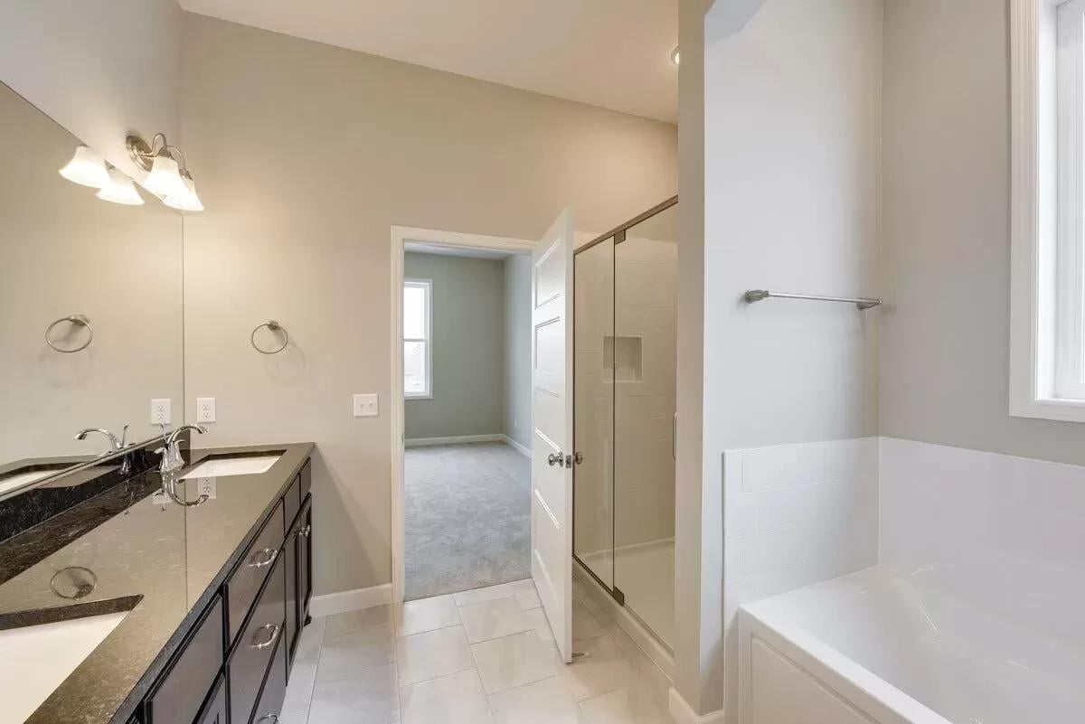 Appreciate the Sleek Dual Vanity and Walk-In Shower in This Craftsman Bath
