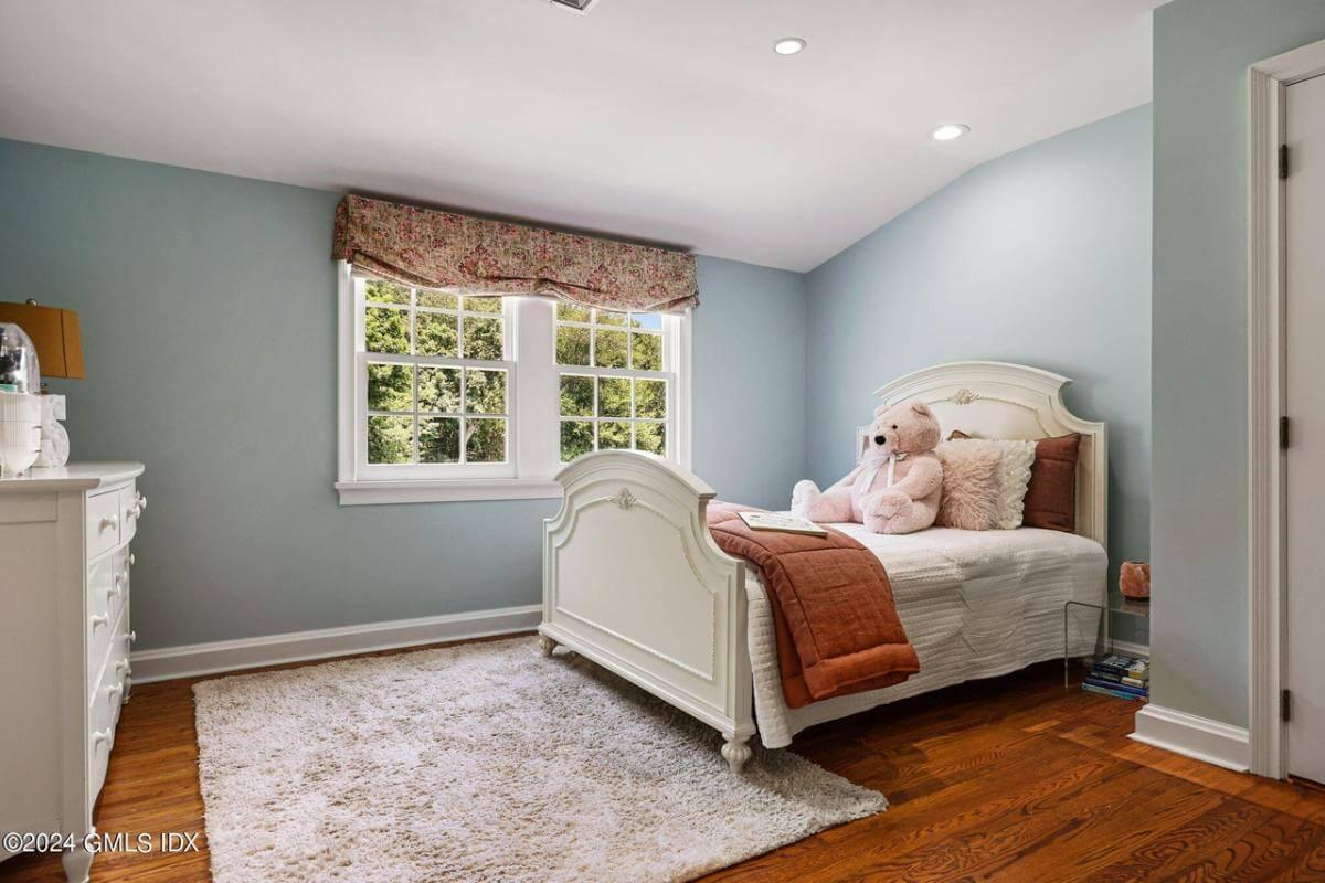 Delight in This Whimsical Bedroom with Plush Teddy Companion