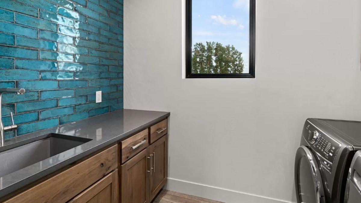 Wow, Check Out the Vibrant Teal Backsplash in This Laundry Room