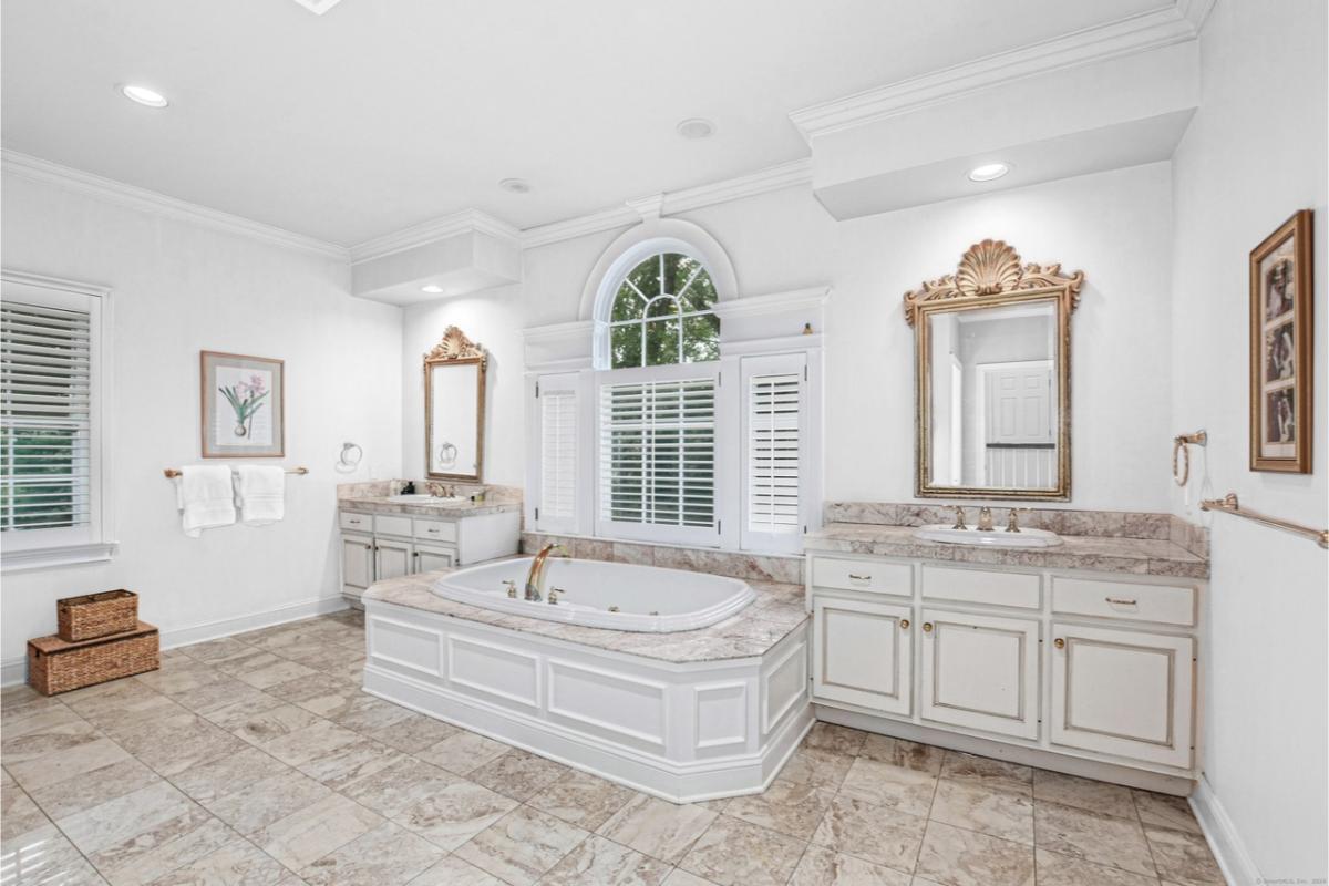 Luxurious Bathroom with a Sunken Tub and Generous Marble Accents