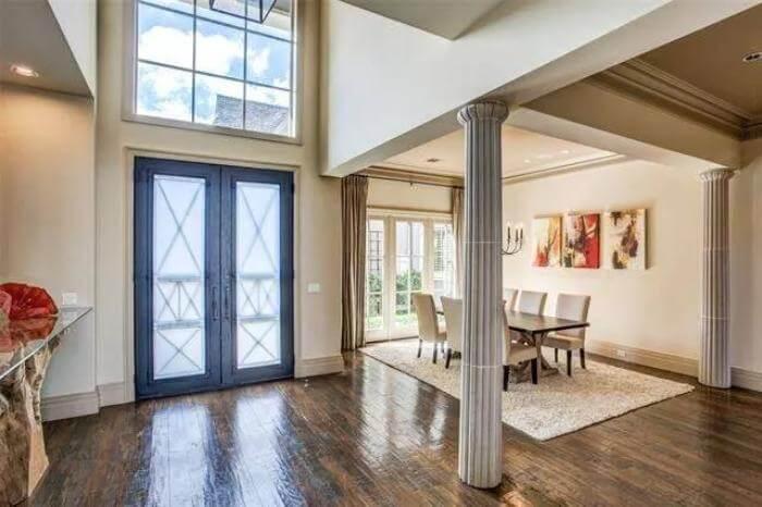 Grand Entrance with Intricate Columns Leading to a Formal Dining Space