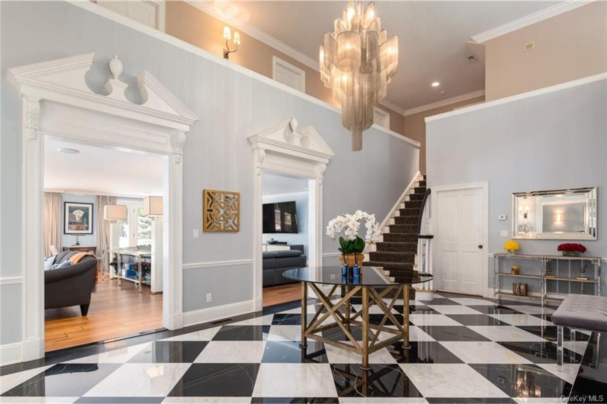 Grand Entrance with Marble Floors and Dramatic Chandelier