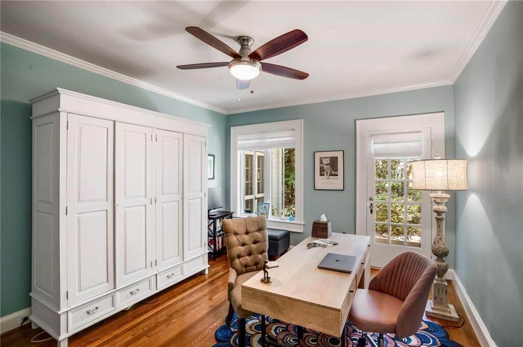 Charming Study with Subtle Blue Walls and a Functional Workspace