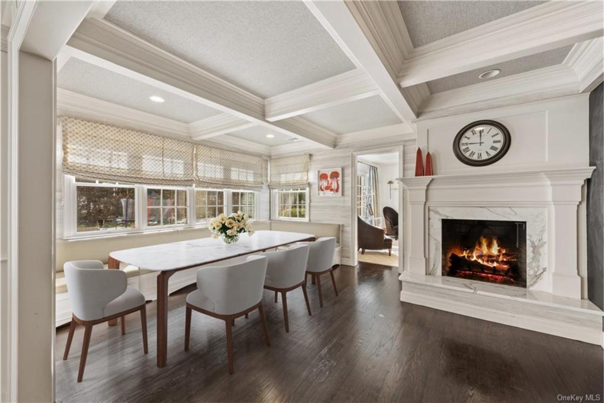Elegant Dining Room with Cozy Fireplace and Expansive Window Seat