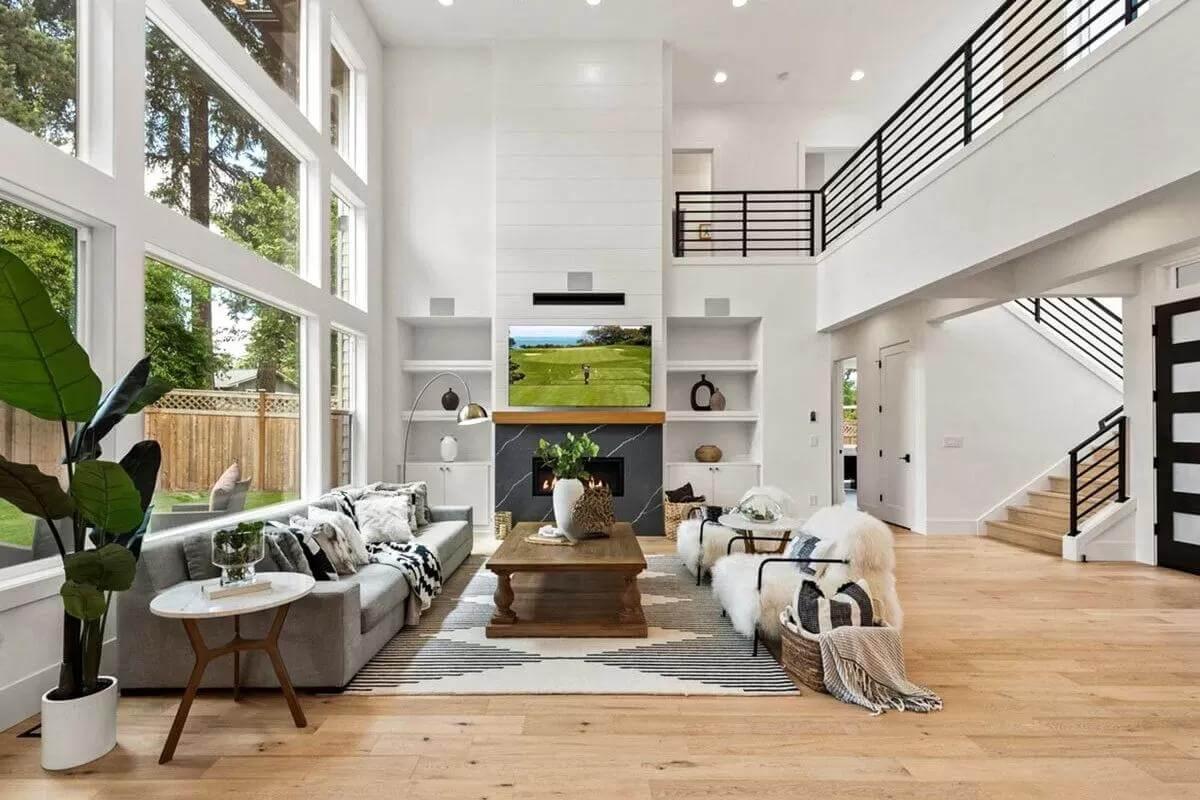 Sky-High Ceilings and Sleek Black Railings Make This Living Room a Showstopper