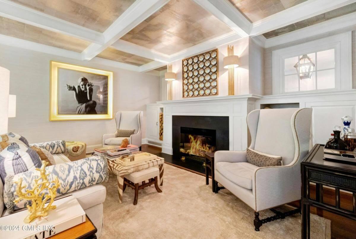Admire the Bold Art and Sophisticated Wingback Chairs in This Elegant Study