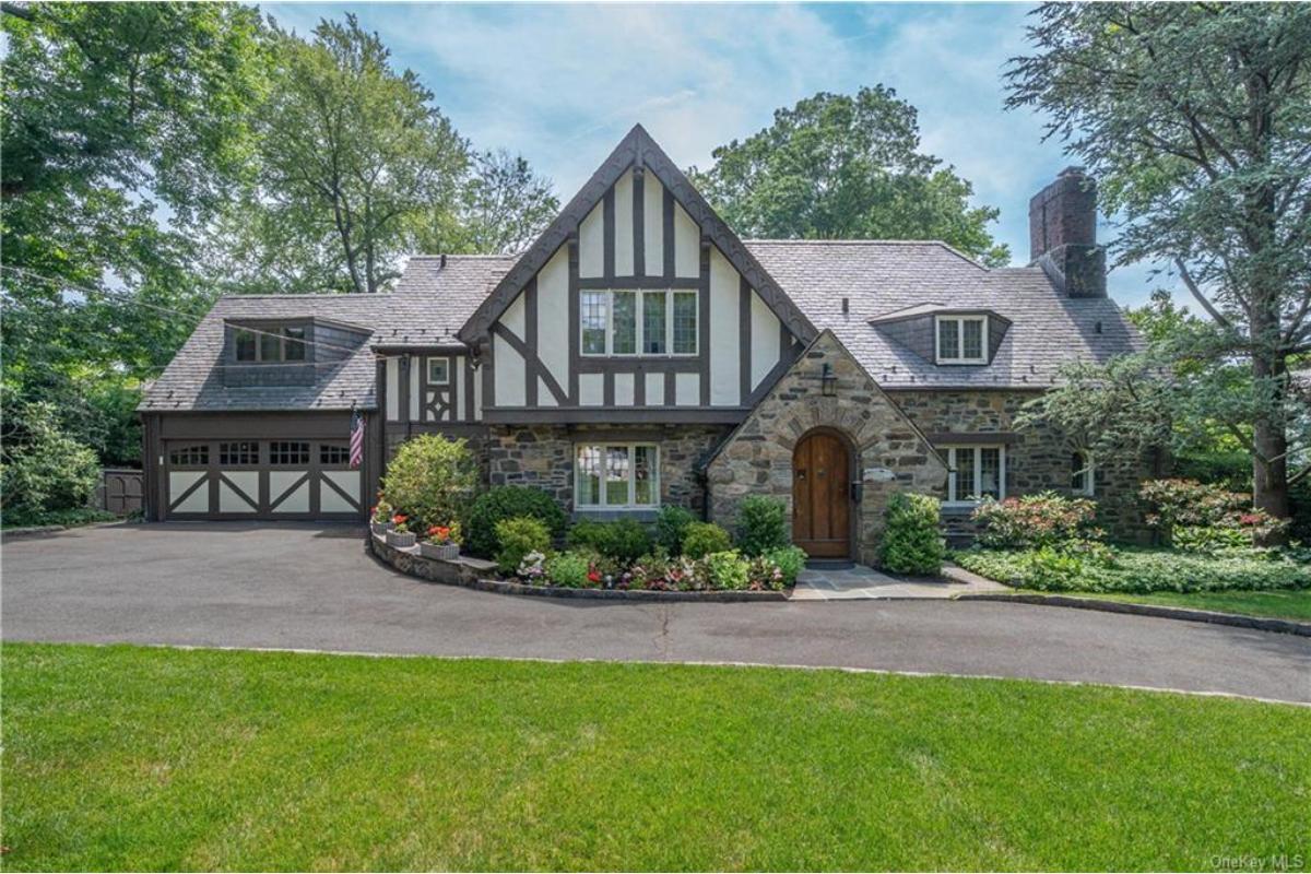 Charming Tudor Revival with a Stone Facade and Timber Accents