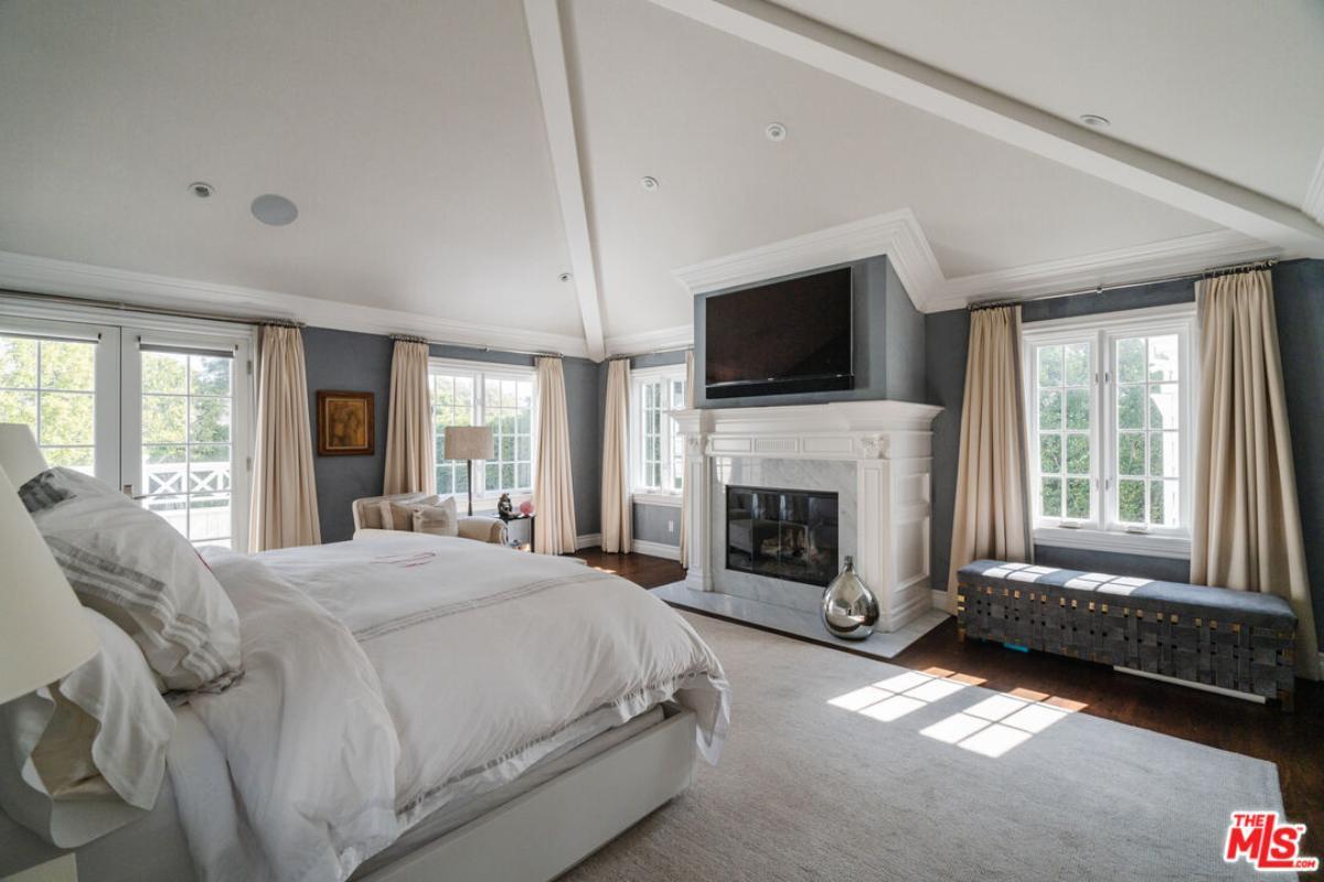 Primary Bedroom with Vaulted Ceilings and a Luxe Fireplace