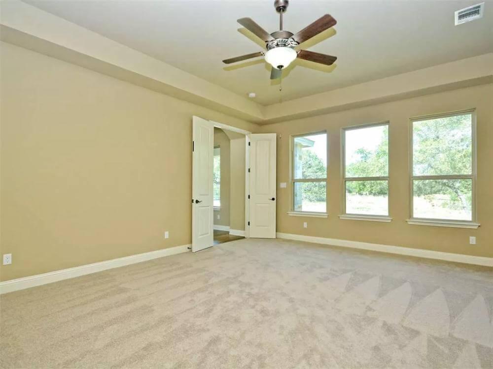 Spacious Bedroom with Tray Ceiling and Outdoor Views