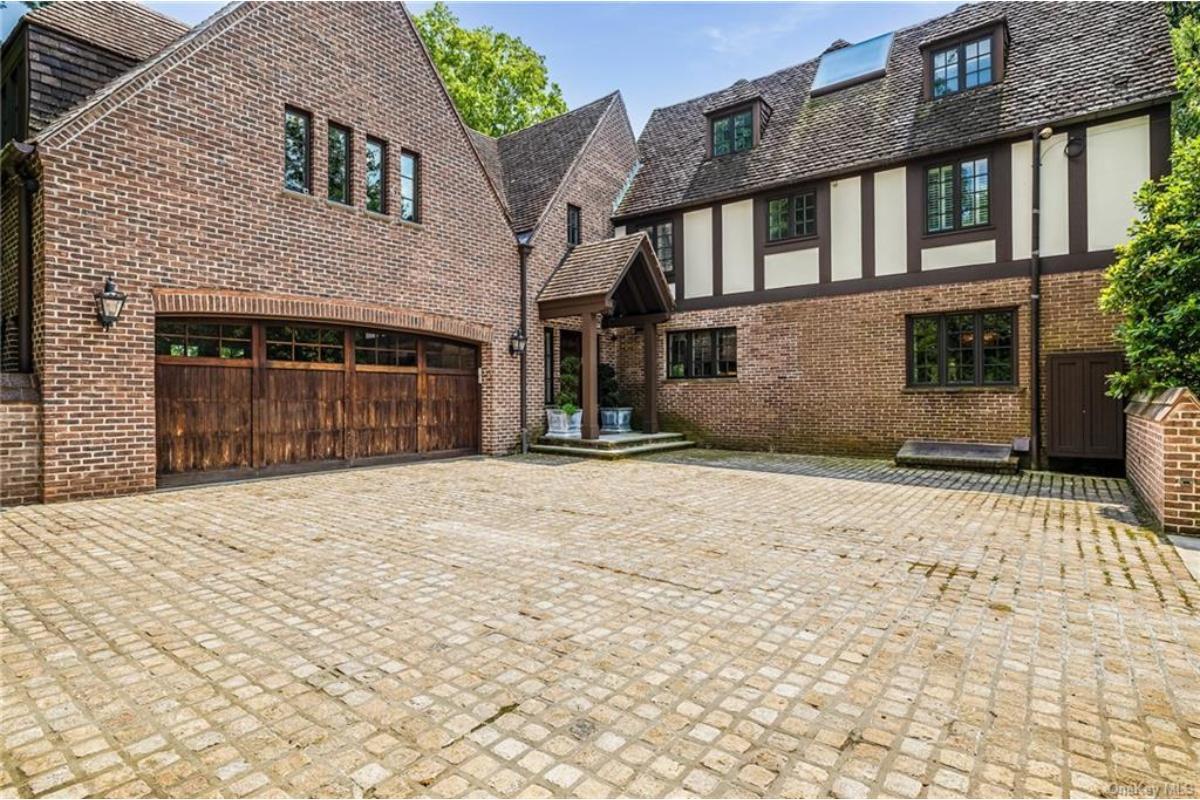 Marvel at the Charming Cobblestone Driveway in This Tudor Revival