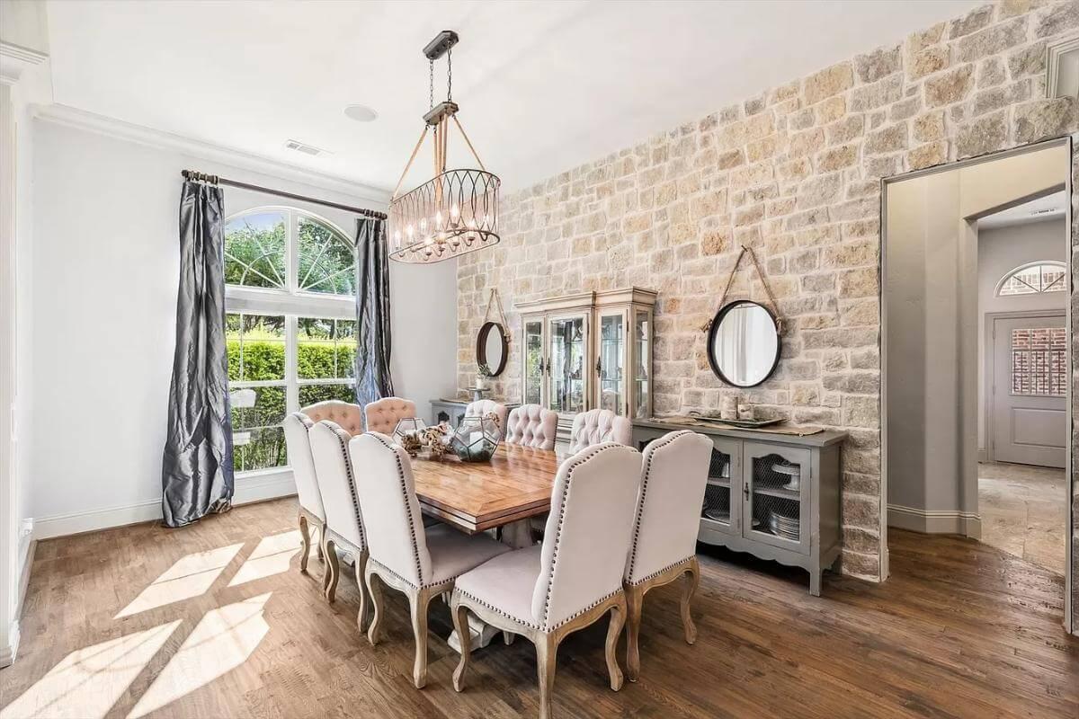 Stone Accent Wall Adds Rustic Warmth to This Elegantly Furnished Dining Room