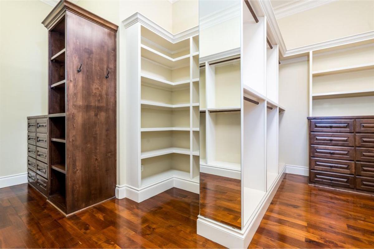 Expansive Walk-In Closet Featuring Organized Shelving and Rich Wood Accents