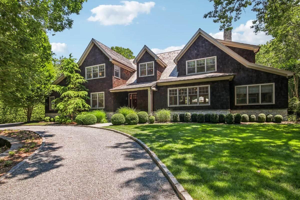 Admire the Classic Gabled Rooflines and Lush Landscaping of This Craftsman Beauty