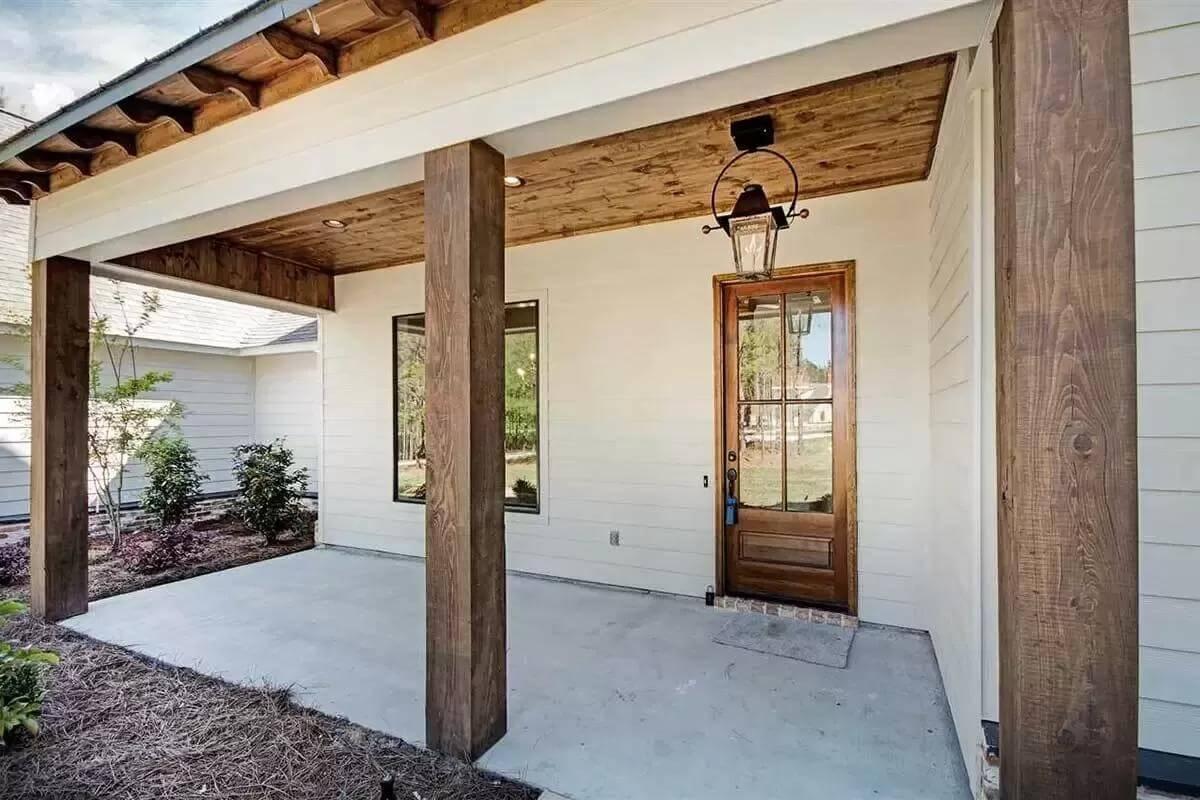 Notice the Wooden Columns Framing This Welcoming Porch