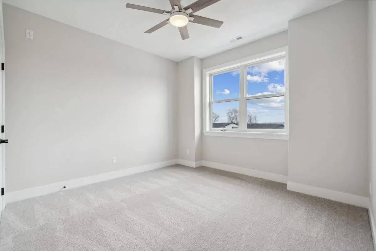 Check Out This Spacious and Bright Bedroom with a Modern Ceiling Fan