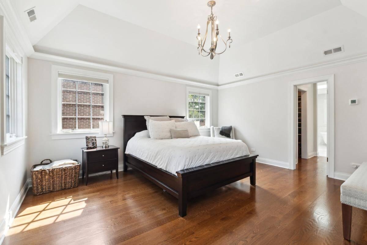 Relax in This Spacious Bedroom with Vaulted Ceilings and Classic Chandelier