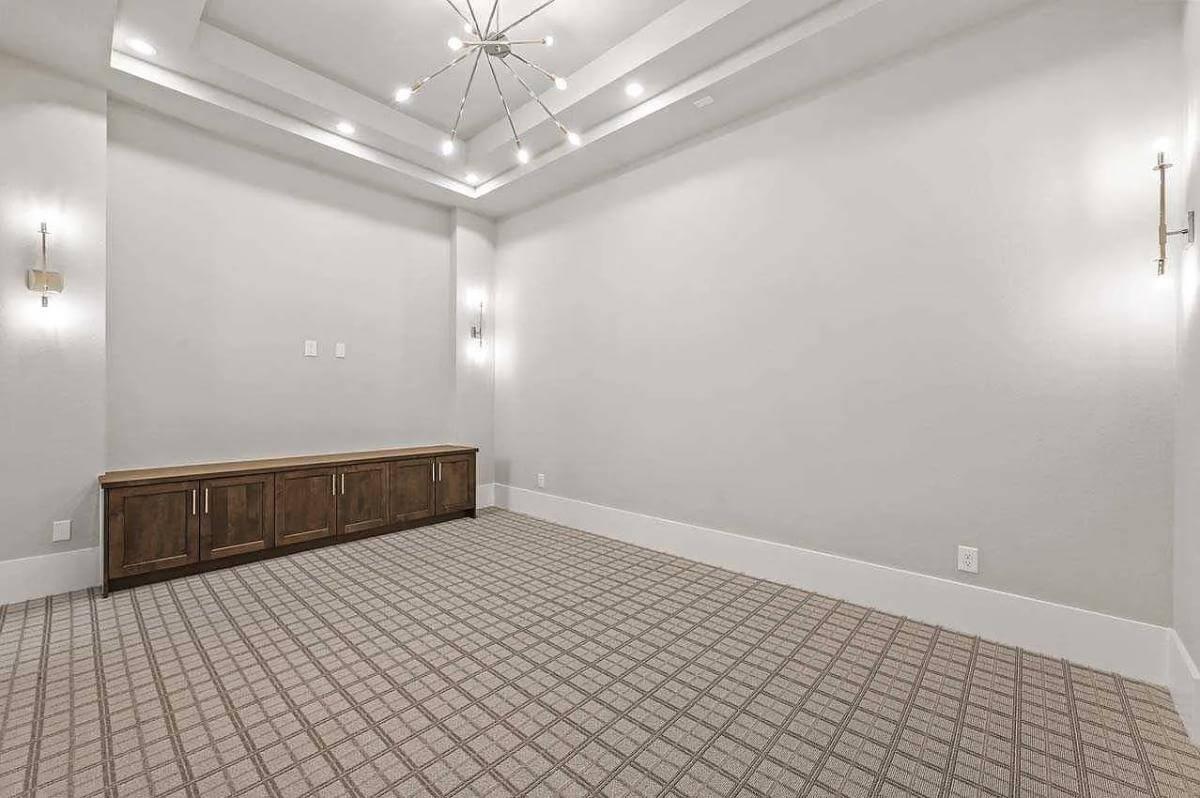 Take In the Unique Lighting and Textured Carpet in This Multi-Purpose Room