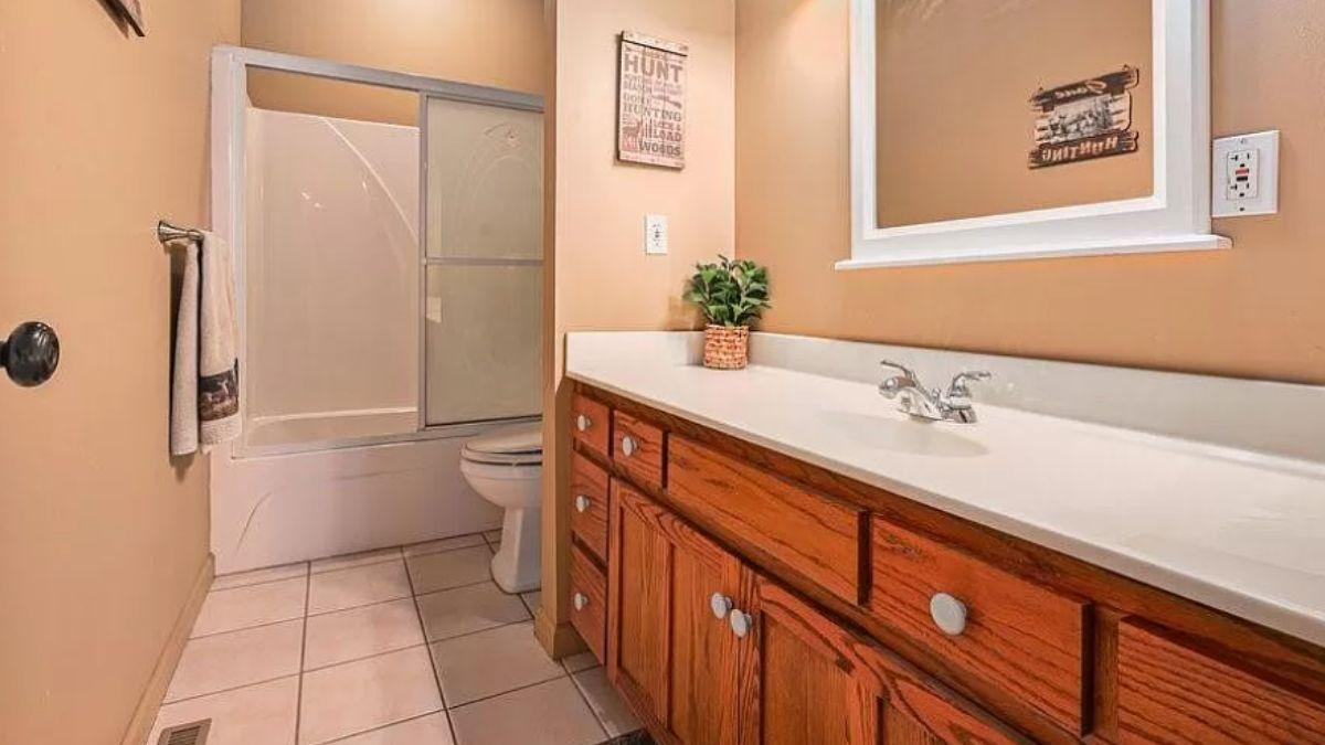 Cozy Bathroom with Rustic Warmth and Practical Storage