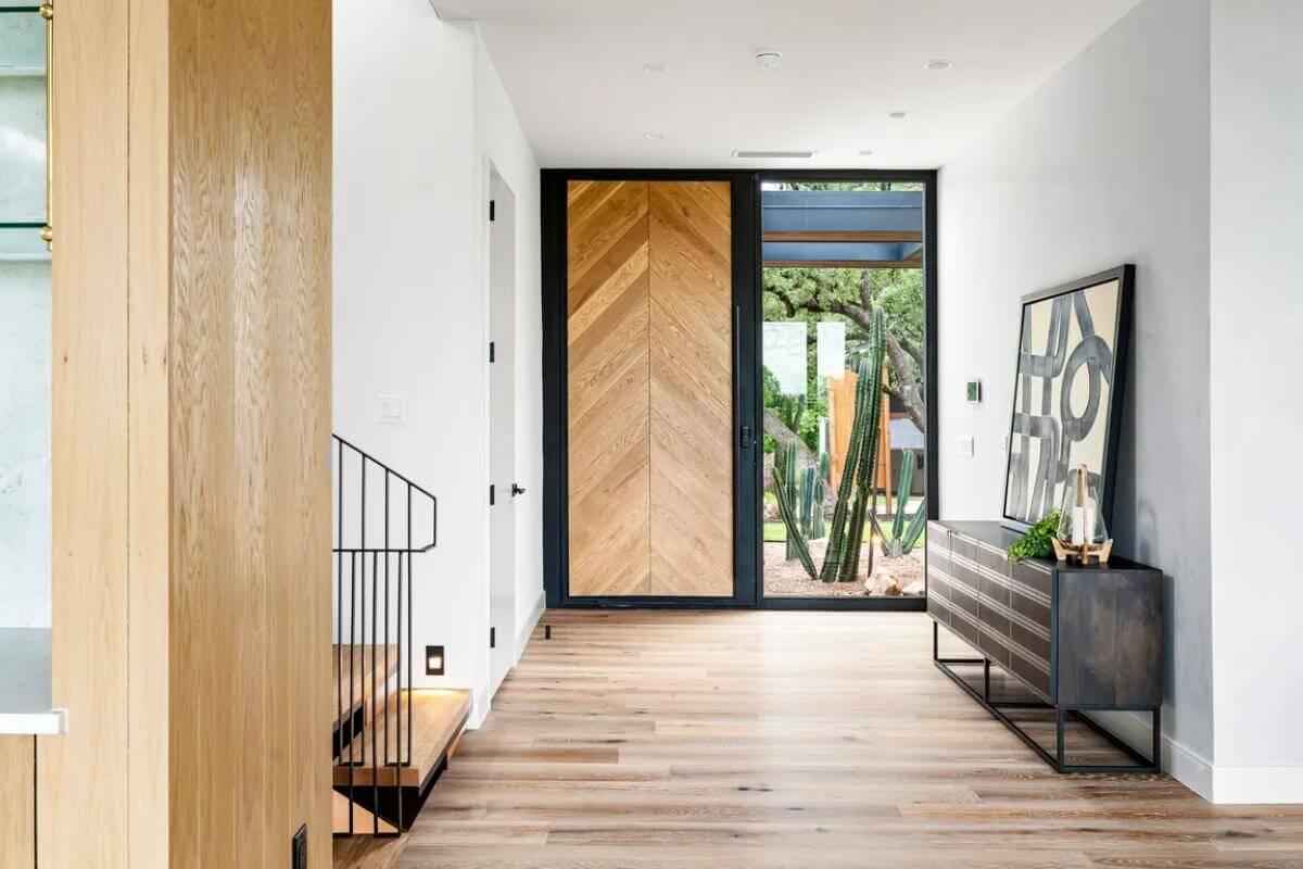 Wow, Check Out the Chevron Wood Front Door Framing a View of Nature