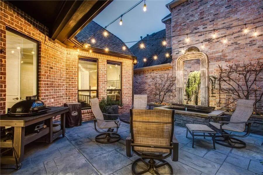 Relax Under Twinkling String Lights in This Brick Patio