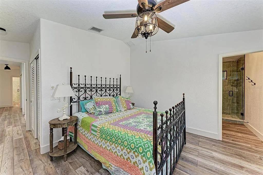 Eclectic Bedroom with Ornate Wrought Iron Bedframe and Wood Accents