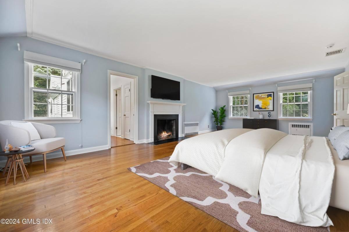 Relax and Unwind in This Spacious Bedroom with Fireplace Comfort