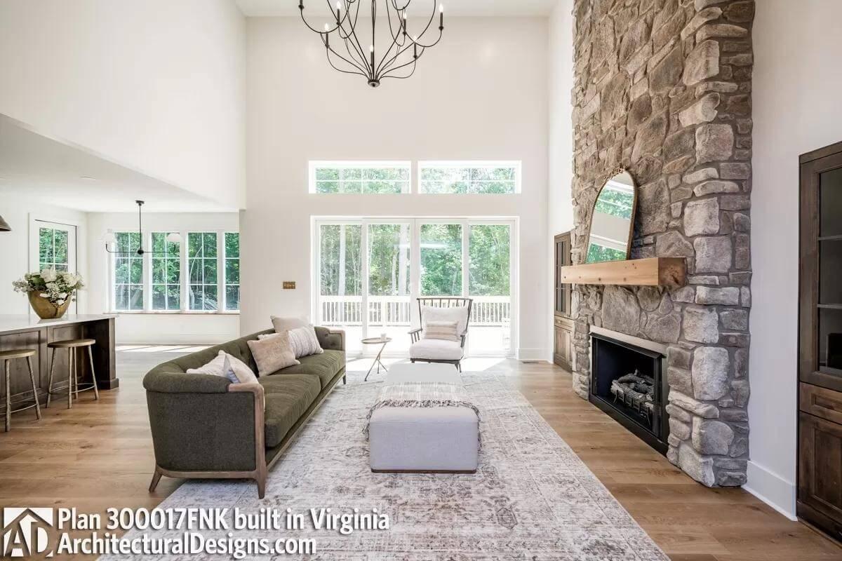 Stone Fireplace Anchors This Bright Living Room with Tall Ceilings