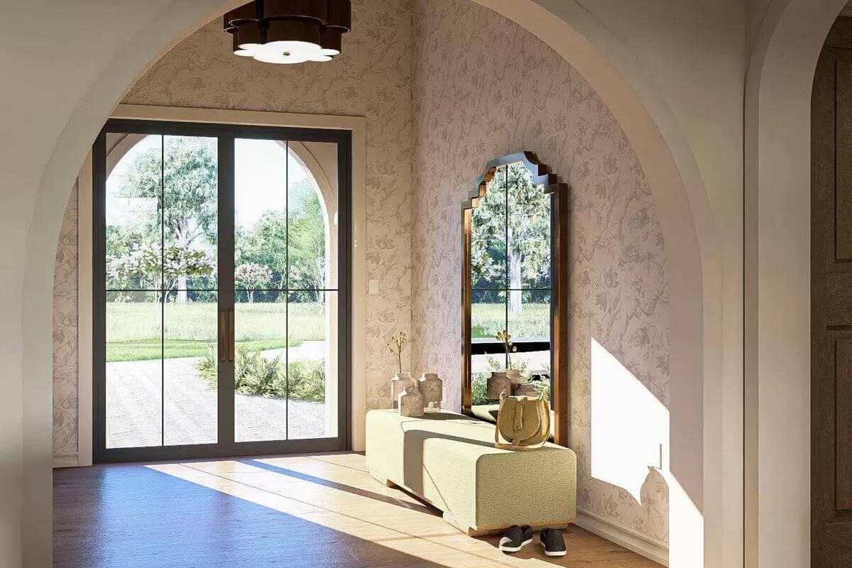 Curved Elegance in the Foyer with Arched Doorways and a Statement Mirror