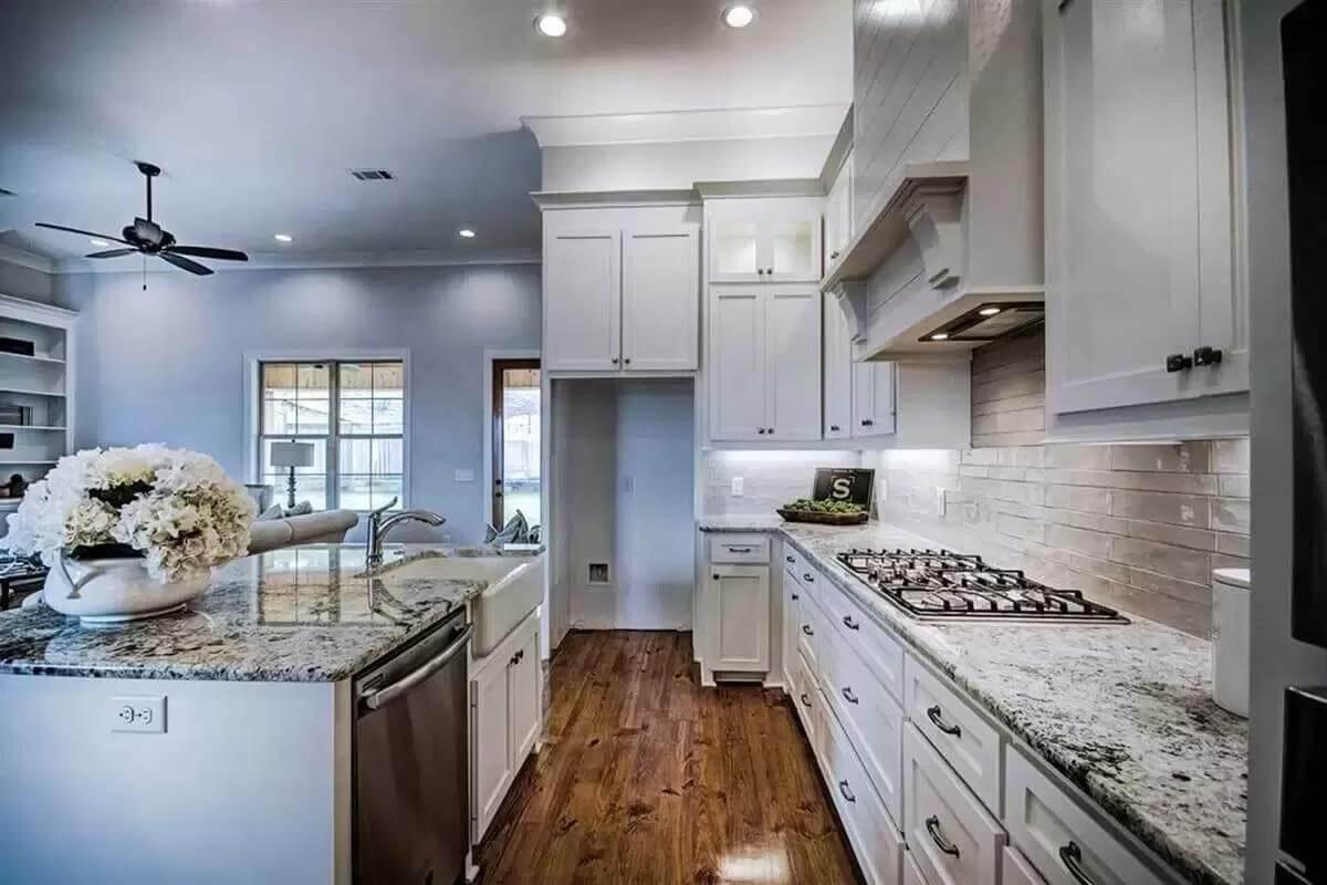 Classic Craftsman Kitchen With Granite-Topped Island and Farmhouse Sink