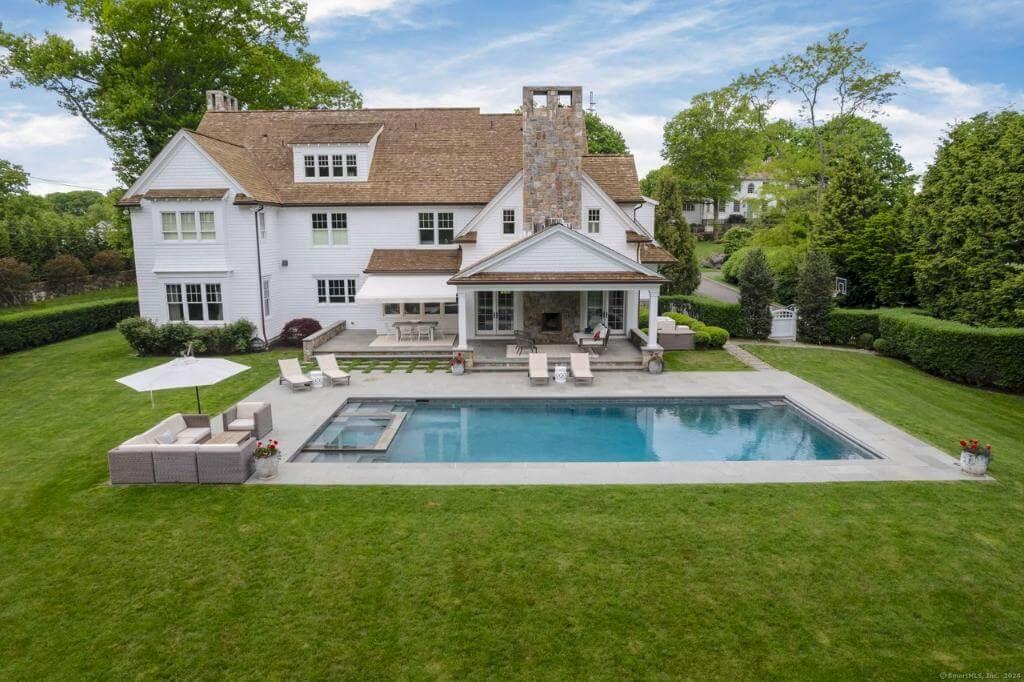 A Backyard Oasis with Inviting Pool and Stone Chimney