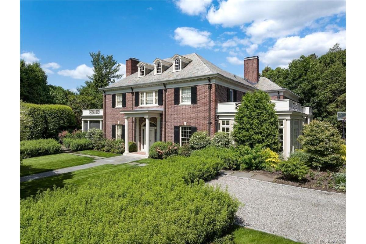 Elegance in Brick with Classic Columns and Dormer Windows