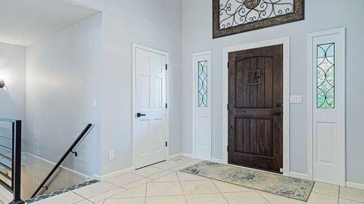 Step Inside to This Warm Foyer with a Rustic Wooden Door