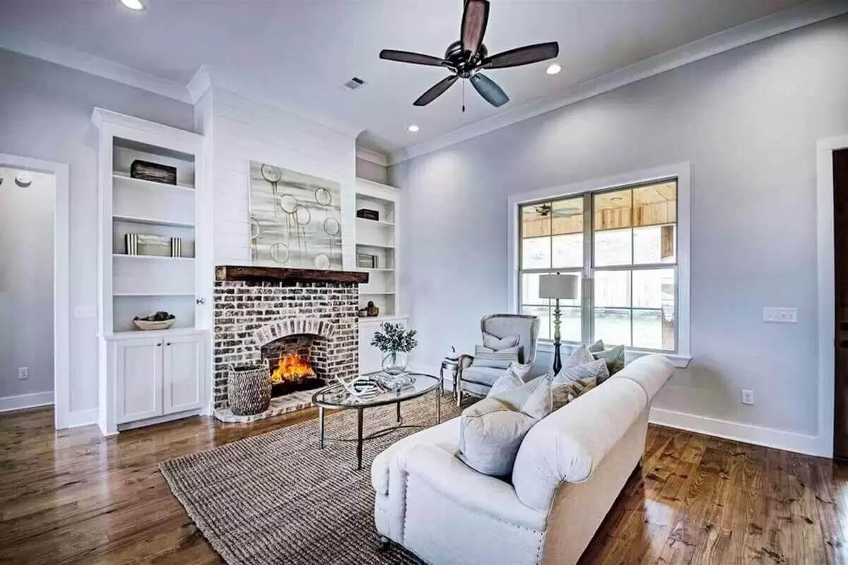 Rustic Living Room with Brick Fireplace and Built-In Shelves