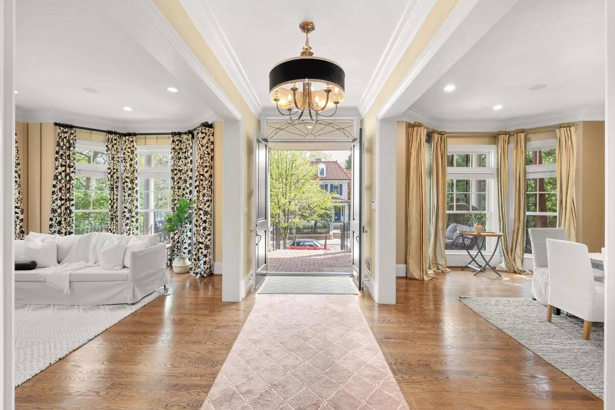 Bright Entryway with Stylish Chandelier and Dual Living Spaces