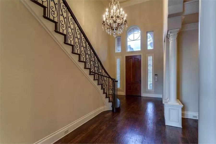 Elegant Foyer with Sweeping Staircase and Chandelier
