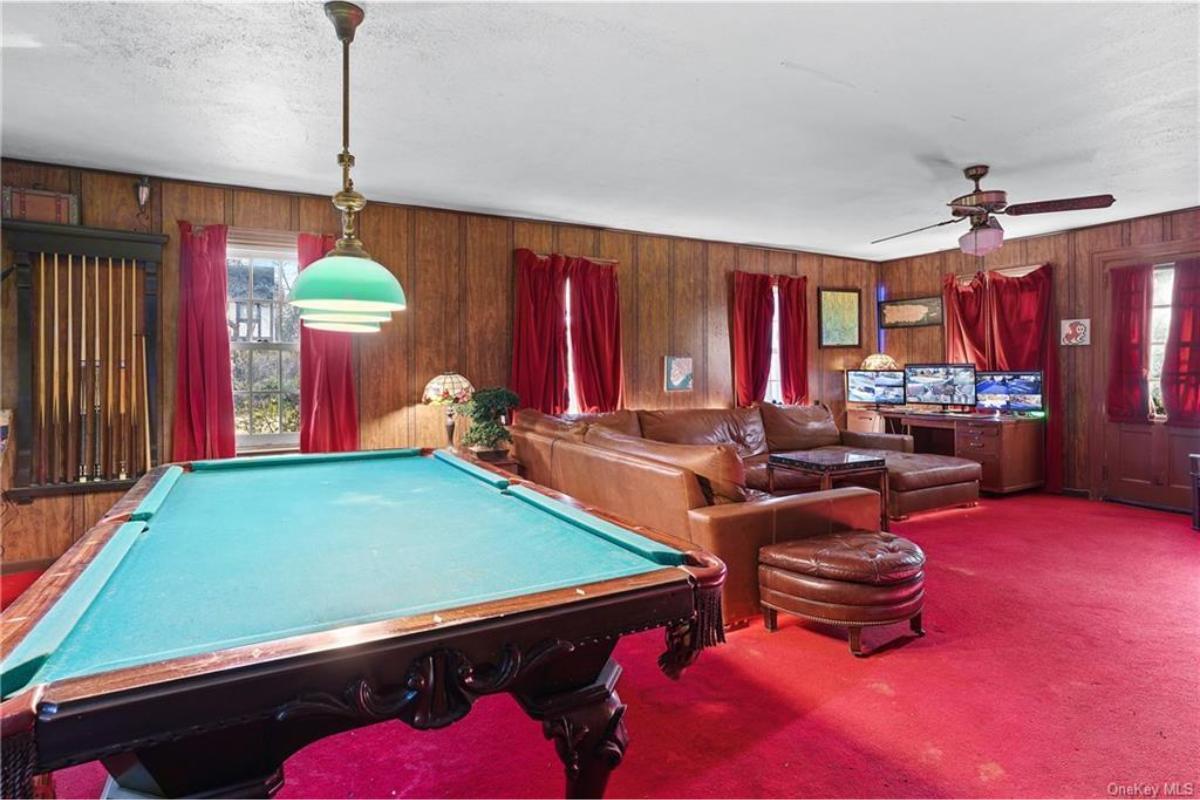 Retro Game Room with Pool Table and Bold Red Carpet