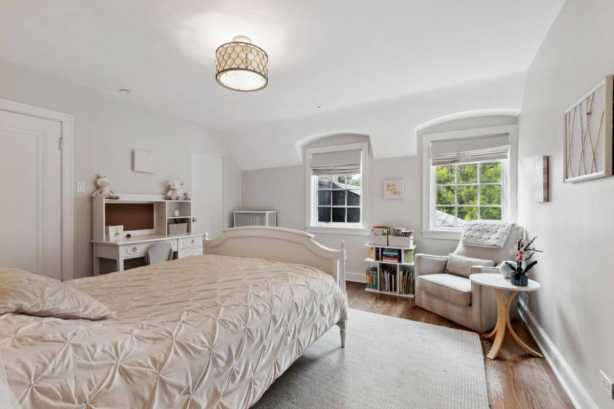 Charming Bedroom with Dormer Windows and a Chic Desk Area