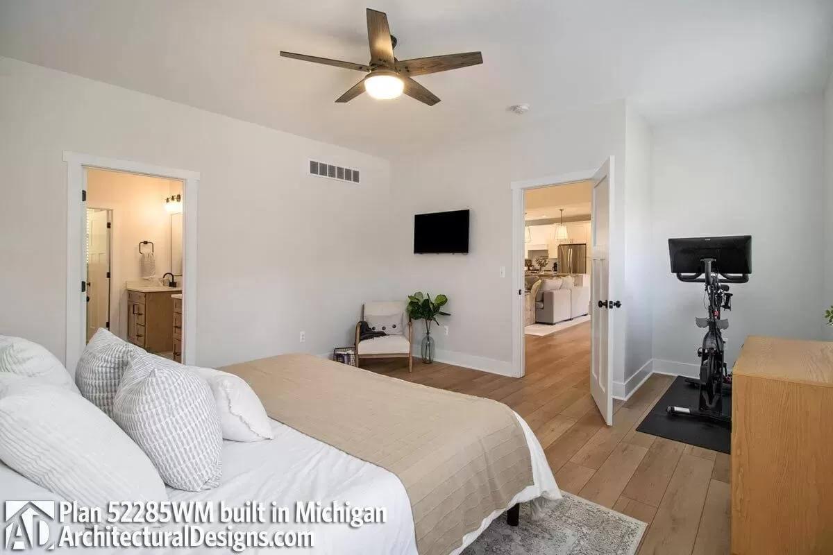 Bedroom with Exercise Nook and Light Wood Accent Flooring