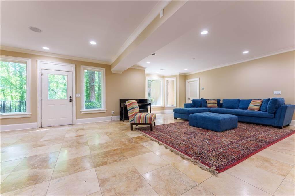 Enjoy the Spacious Room with Bold Blue Sofa and Elegant Rug