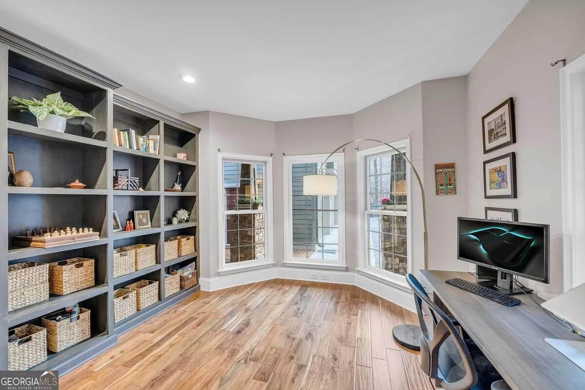 Step into This Inviting Study with Built-in Shelves and Bay Windows