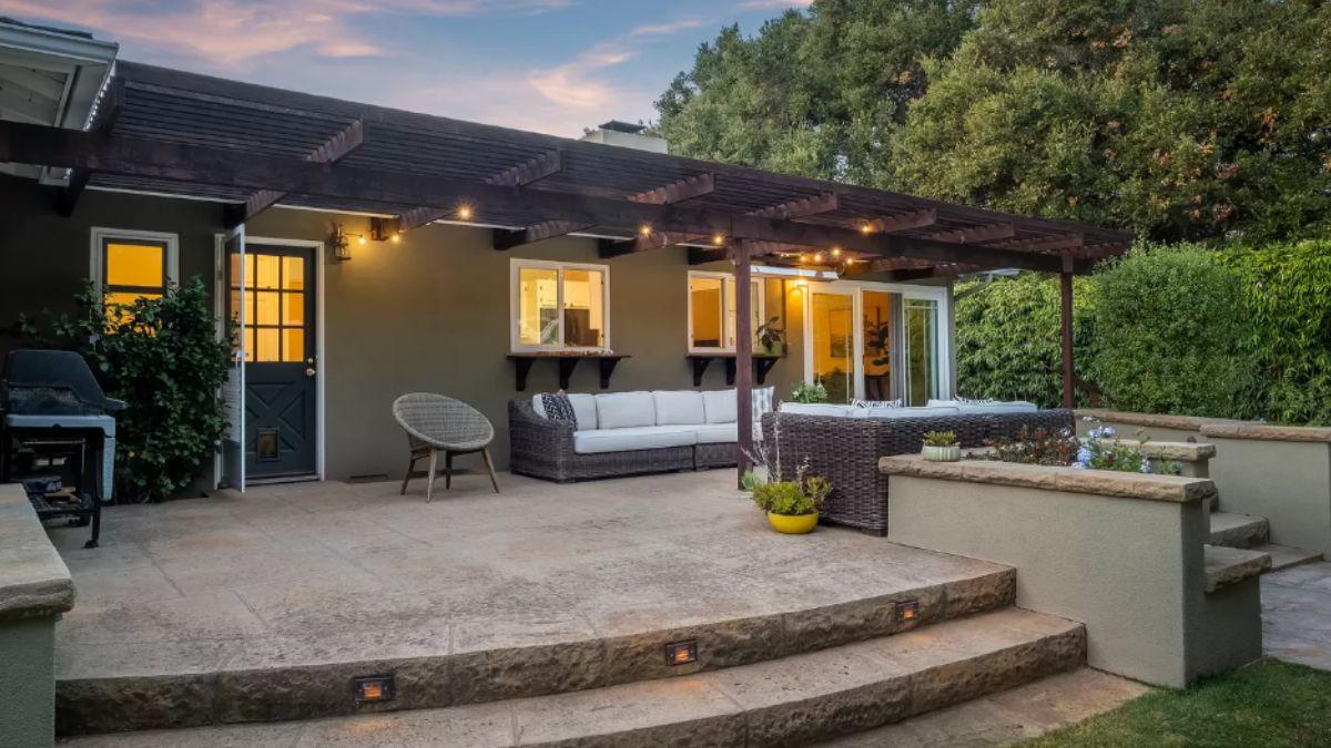 Explore This Relaxing Patio with a Wooden Pergola and Cozy Seating