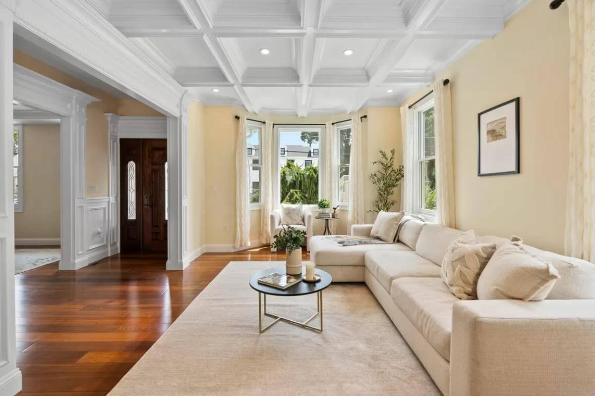 Elegant Living Room with Highlighted Coffered Ceiling and Bay Windows