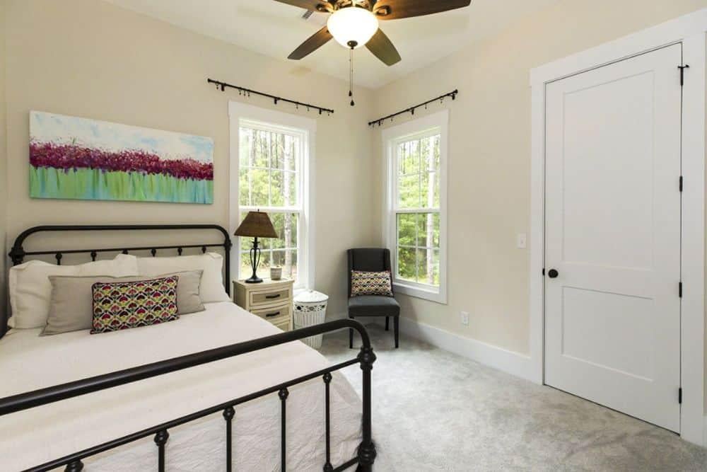 Craftsman Bedroom with Wrought Iron Bed and Scenic View
