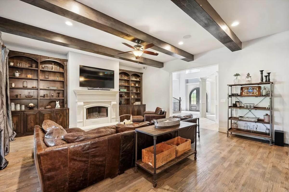 Warm Family Room with Built-In Shelving and Exposed Beams