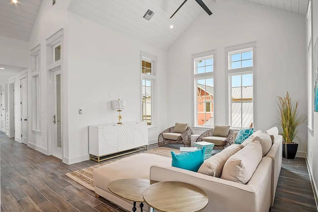 Tall Windows and Vibrant Accents in a Bright Living Room