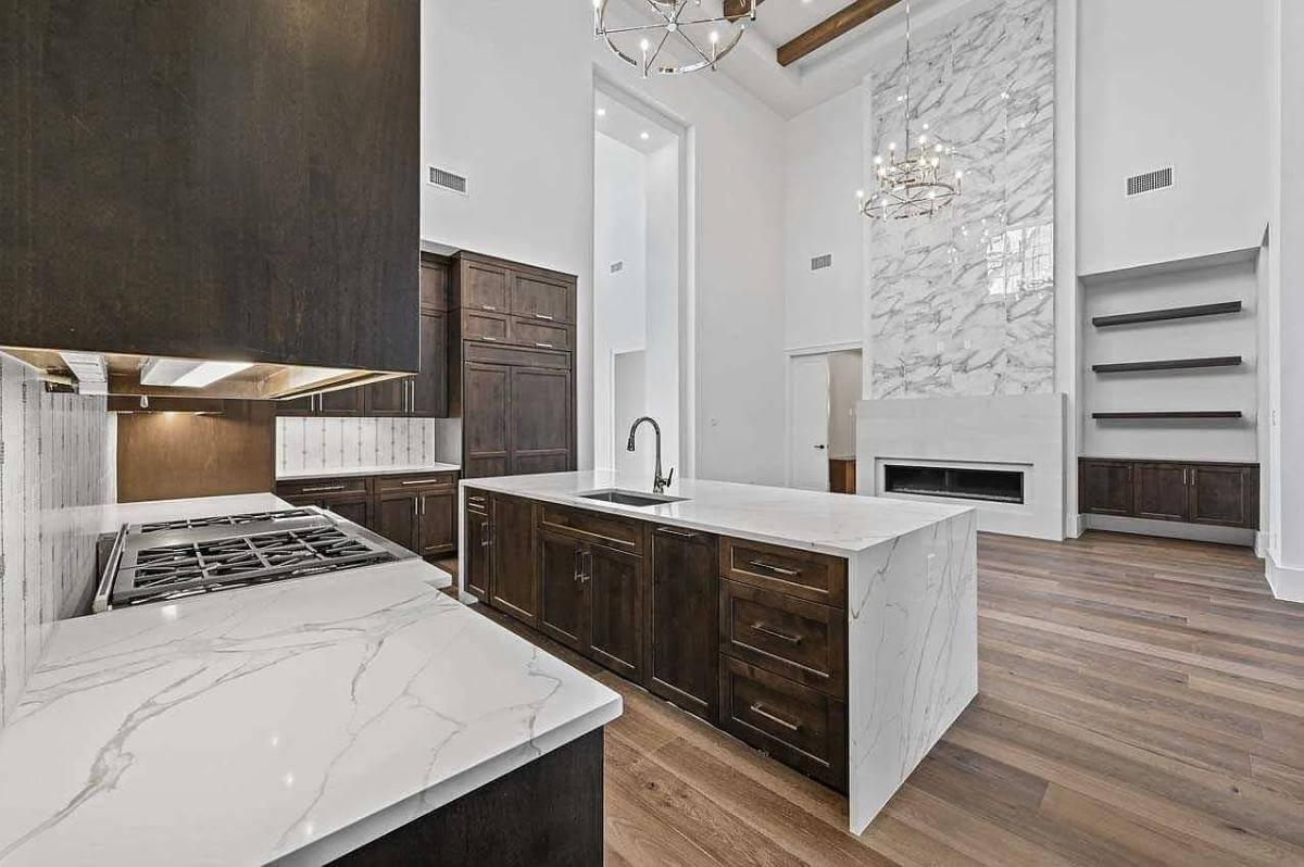 Admire the Marble Fireplace and Open Shelving in This Inviting Space