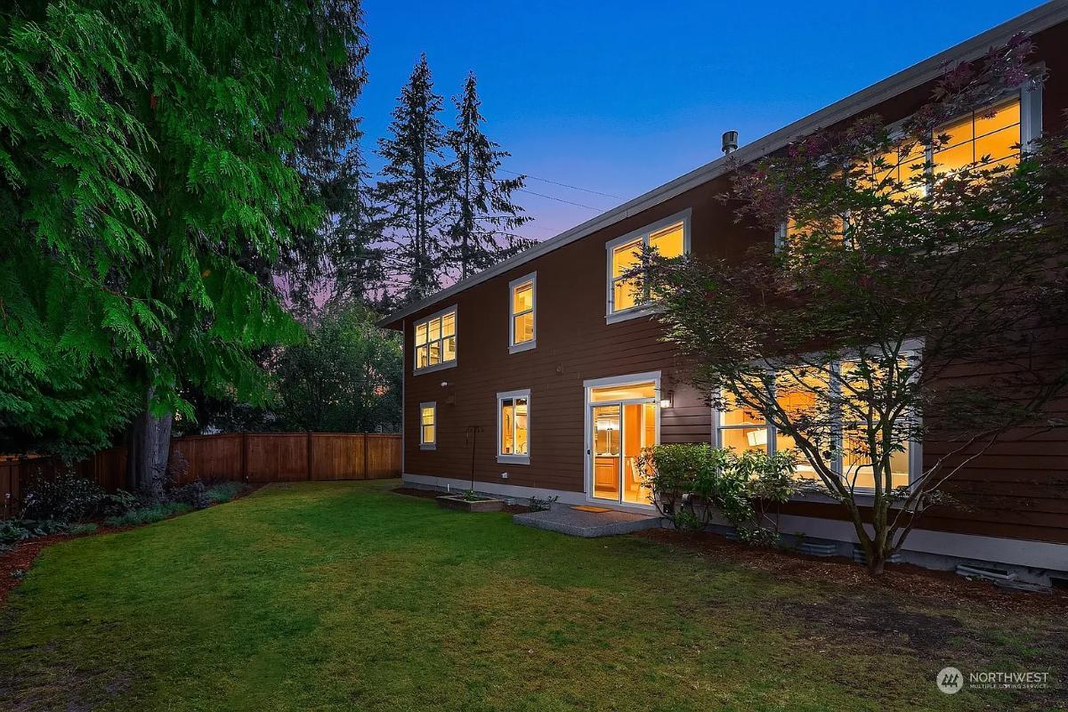 Evening Charm of a Craftsman Backyard with Warm Interior Glow