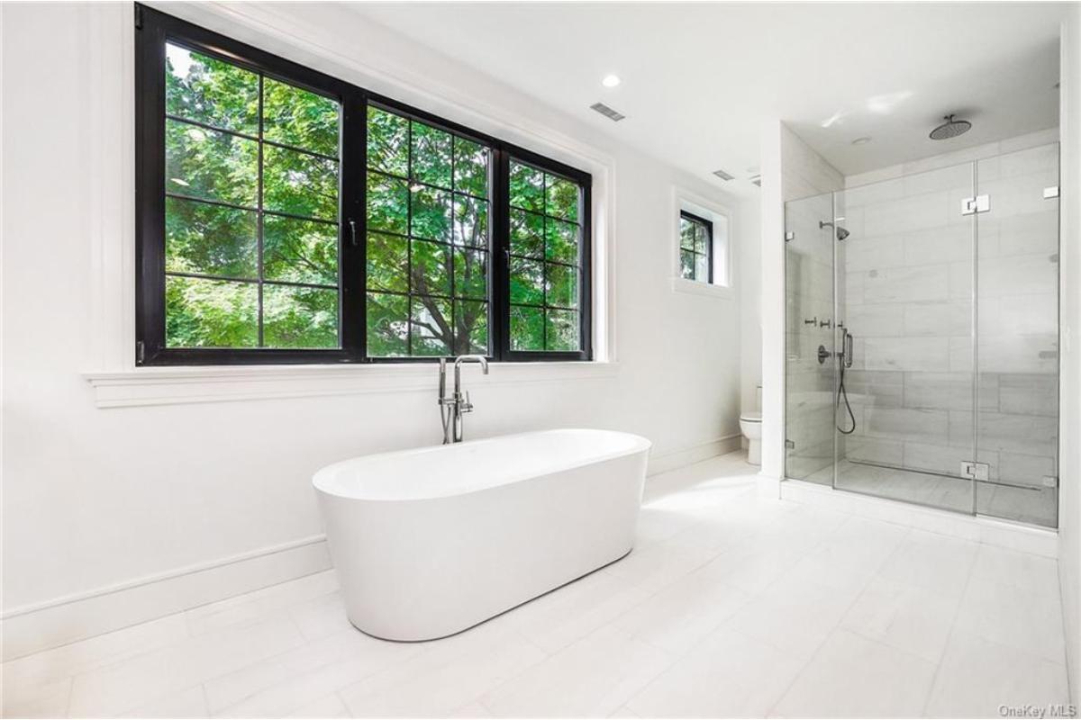 A Clean and Minimalist Bathroom with a Freestanding Tub and Scenic Views
