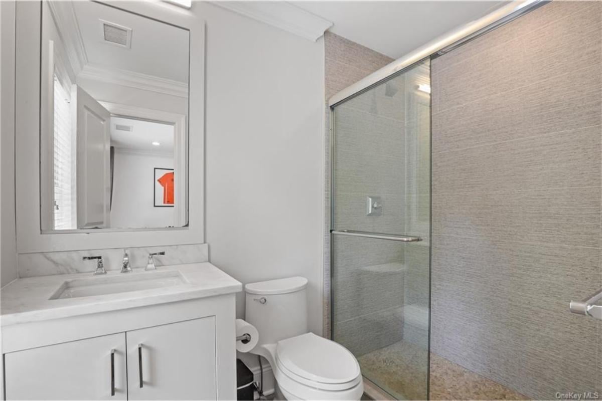 Compact Bathroom Elegance with Marble and Glass Highlights